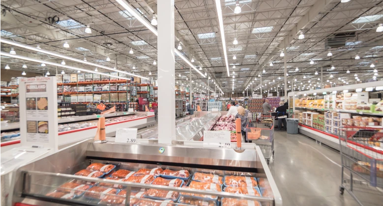 Photo of a warehouse club – view from the deli aisle where raw meat can be seen.